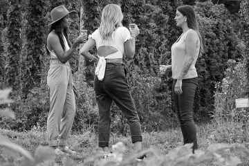 a group of people standing in the grass