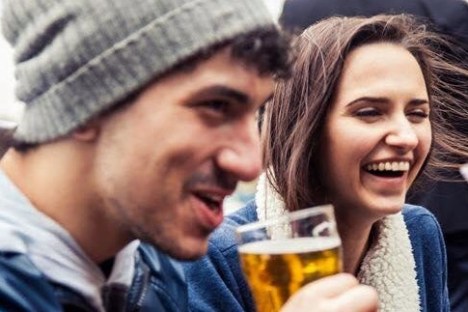 a close up of a man and a woman looking at the camera