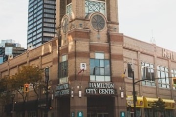 a clock tower in the middle of a city street