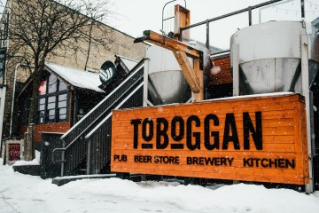 a sign on the side of a snow covered street